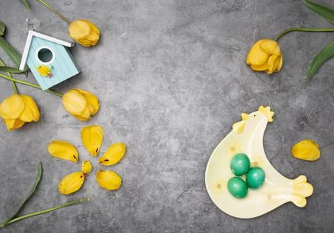Easter layout, a plate of chicken and yellow chicks, by green eggs ,tulips Stock Photos