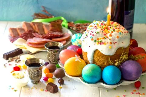 Easter meal Breakfast. Easter cake, painted eggs and delicious delicatessen. Stock Photos