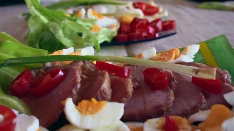 Easter meal with eggs, ham, onion, cheese, man preparing food for celebrations Stock Footage 253522178