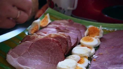 Easter meal with eggs, ham, onion, cheese, man preparing food for celebrations Stock Footage 253522179