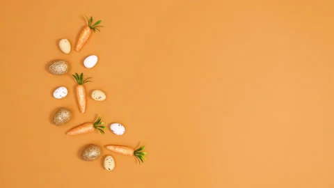 Easter minimal arrangement made of eggs and carrots on left side. Stop motion Stock Footage 150277861