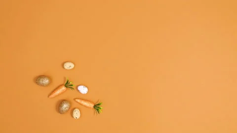 Easter minimal decoration made of eggs and carrots on left side. Stop motion Stock Footage 150277625