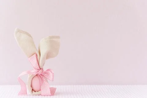 Easter mockup background with bunny easter egg on pink cover background. Stock Photos