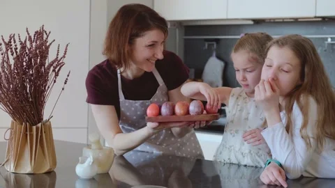 Easter. Mom and two cute daughters are preparing for the traditional spring Stock Footage 183425616