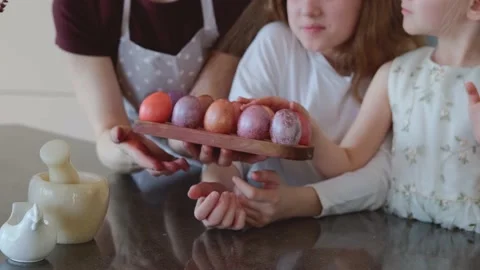 Easter. Mom and two cute daughters are preparing for the traditional spring Stock Footage 183425800