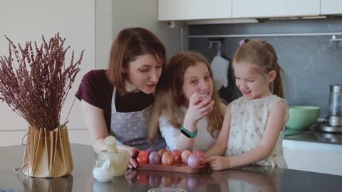 Easter. Mom and two cute daughters are preparing for the traditional spring Stock Footage 183426125