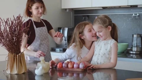 Easter. Mom and two cute daughters are preparing for the traditional spring Stock Footage 183426543