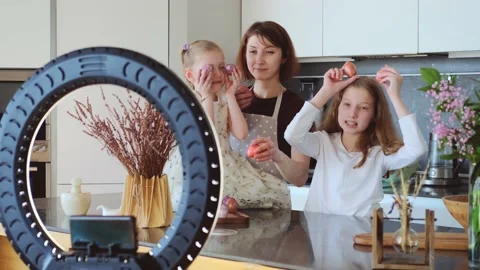 Easter. Mom and two cute daughters are preparing at home for the traditional Stock-Footage 183443872