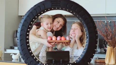 Easter. Mom and two cute daughters are preparing at home for the traditional Video stock 183800181