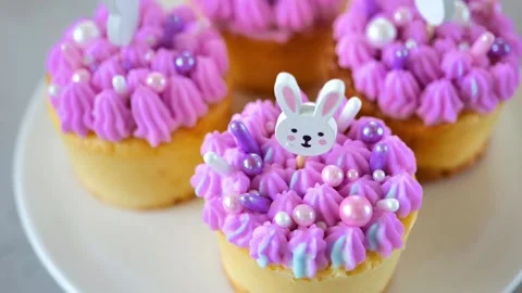 Easter Muffins. Easter cupcakes with white rabbits topiary Stock Footage 297702836