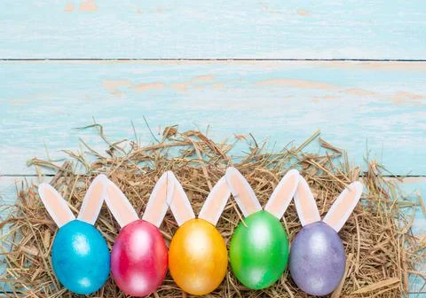 Easter multi-colored eggs and rabbit ears. Flat lay Stock Photos