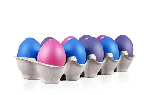 Easter multi-colored eggs ten pieces in a box on a isolated on white background. Stock Photos