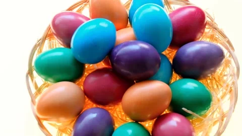 Easter multicolored eggs in a wicker bowl on a white background.Approximation. Stock Footage 227343697