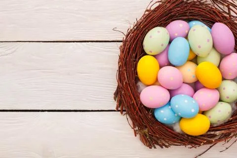 Easter objects eggs isolated on wooden background in a nest Stock Photos