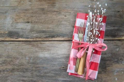 Easter or spring holiday table setting. Antique fork knife, red and white che Stock Photos