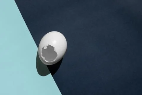 Easter is over. The white shell of egg lies on the transition of two colors. Stock Photos
