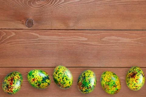 Easter painted eggs with an abstract pattern. On a wooden brown background. 스톡 사진