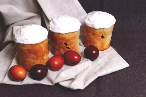 Easter pastries and colored eggs on a textile background. Traditional pastrie Stock Photos