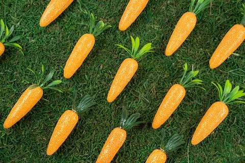 Easter pattern background made of decorative carrots on natural organic texture, Stock Photos