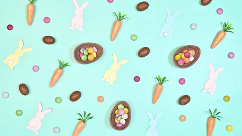 Easter pattern with chocolate eggs, rabbits and carrots appear Stop motion Stock Footage 233229781