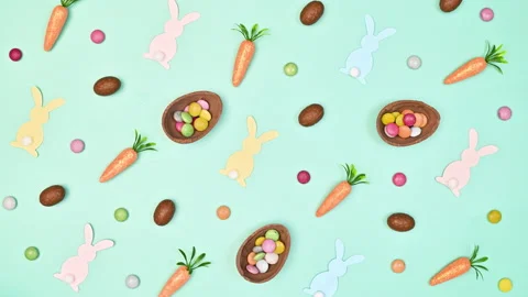 Easter pattern with chocolate eggs, rabbits and carrots move Stop motion Stock Footage 233230077