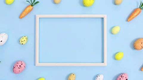 Easter pattern with eggs and carrots and copy space frame . Stop motion flat lay Stock Footage 149926861