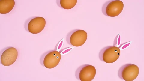 Easter pattern with eggs with rabbit ears on bright pink background. Stop motion Stock Footage 171364073