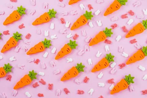 Easter pattern made of decoration with bunny ears sugar sprinkle and orange Stock Photos