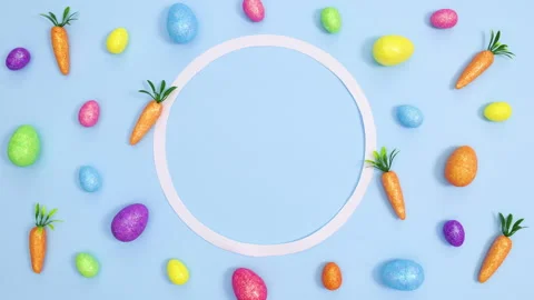 Easter pattern made of vibrant eggs and carrots and copy space . Stop motion Stock Footage 149928062