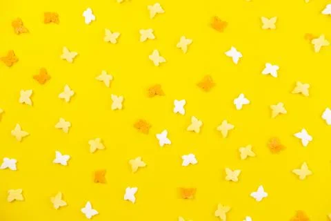 Easter pattern made of white and yellow butterflies on a yellow background. 스톡 사진