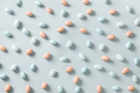 Easter pattern with pastel chocolate eggs on blue background. Stock Photos
