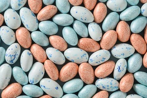 Easter pattern with pastel chocolate eggs on blue background. Stock Photos