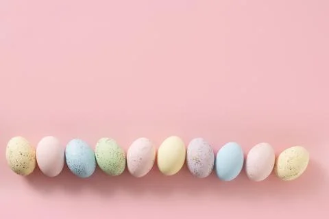 Easter pattern with pastel colorful eggs on pink background. Stock Photos