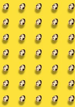 Easter pattern with quail eggs with a shadow on a yellow background. Stock Photos