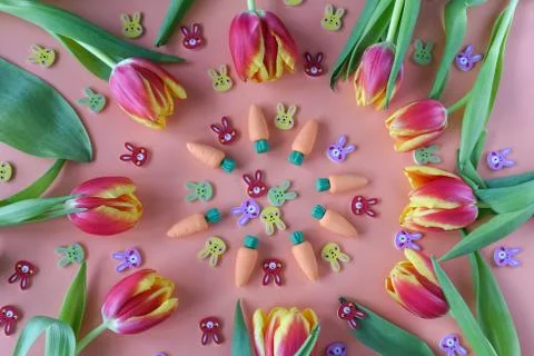 Easter pattern of tulips, carrots and small rabbits Stock Photos