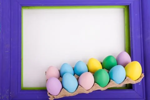 Easter picture frame with easter eggs close up on white background Stock Photos