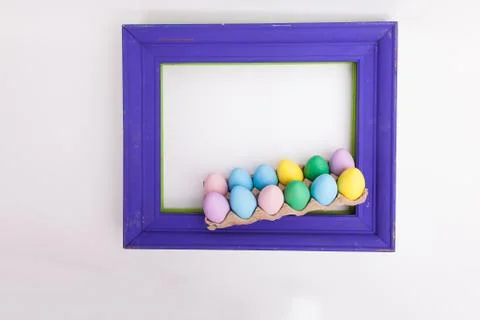 Easter picture frame on white background with carton of easter eggs on the frame Foto stock