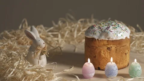 Easter Pie with candles and rabbit on wooden table Stock Footage 87511418