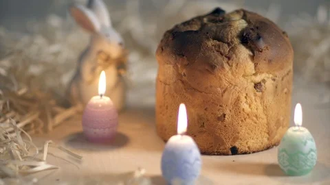 Easter Pie surrounded by candles and rabbit on wooden table Stock Footage 87511413