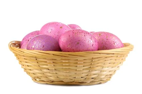 Easter. Pink easter eggs in basket on white isolated background. close-up. Ha Stock Photos
