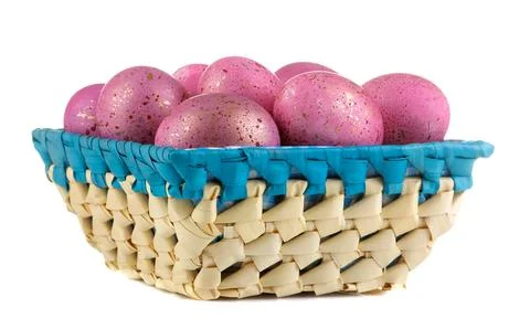 Easter. Pink easter eggs in basket on white isolated background. close-up. Ha Stock Photos