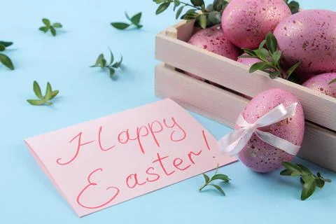Easter. Pink Easter eggs in a box on a trendy blue background. Happy easter. Stock Photos
