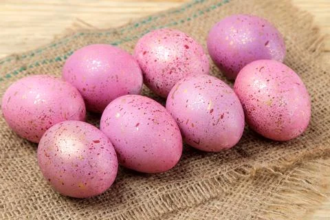 Easter. Pink Easter eggs on a napkin on a natural wooden table. Happy easter. Stock Photos