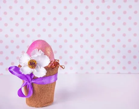 Easter pink egg in a pot on the polka dot background Stock Photos