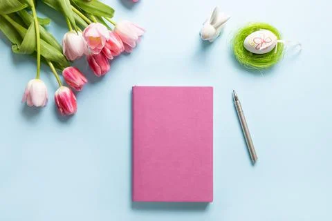 Easter planning with notebook, tulip flowers, egg. Easter greeting card. Stock Photos