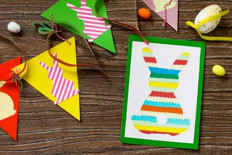 Easter postcard Easter bunny and easter children garland on a wooden table. Stock-Fotos