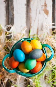 Easter: Pretty Dyed Eggs Sit In Basket On Rustic Background Stock Photos