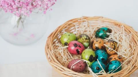 Easter quail eggs in a basket. Easter composition. Holiday concept. Stock Photos