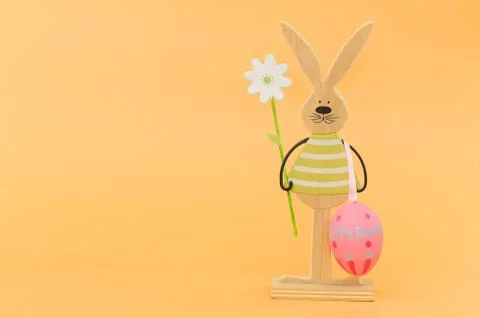 Easter rabbit and egg on orange background, with copy space Stock Photos