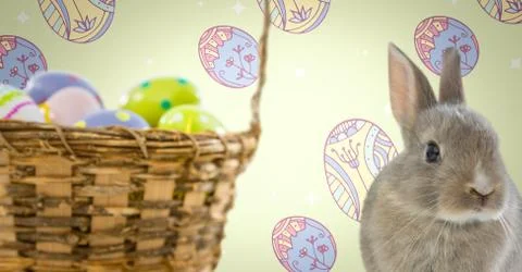 Easter Rabbit with eggs basket in front of pattern Stock Photos